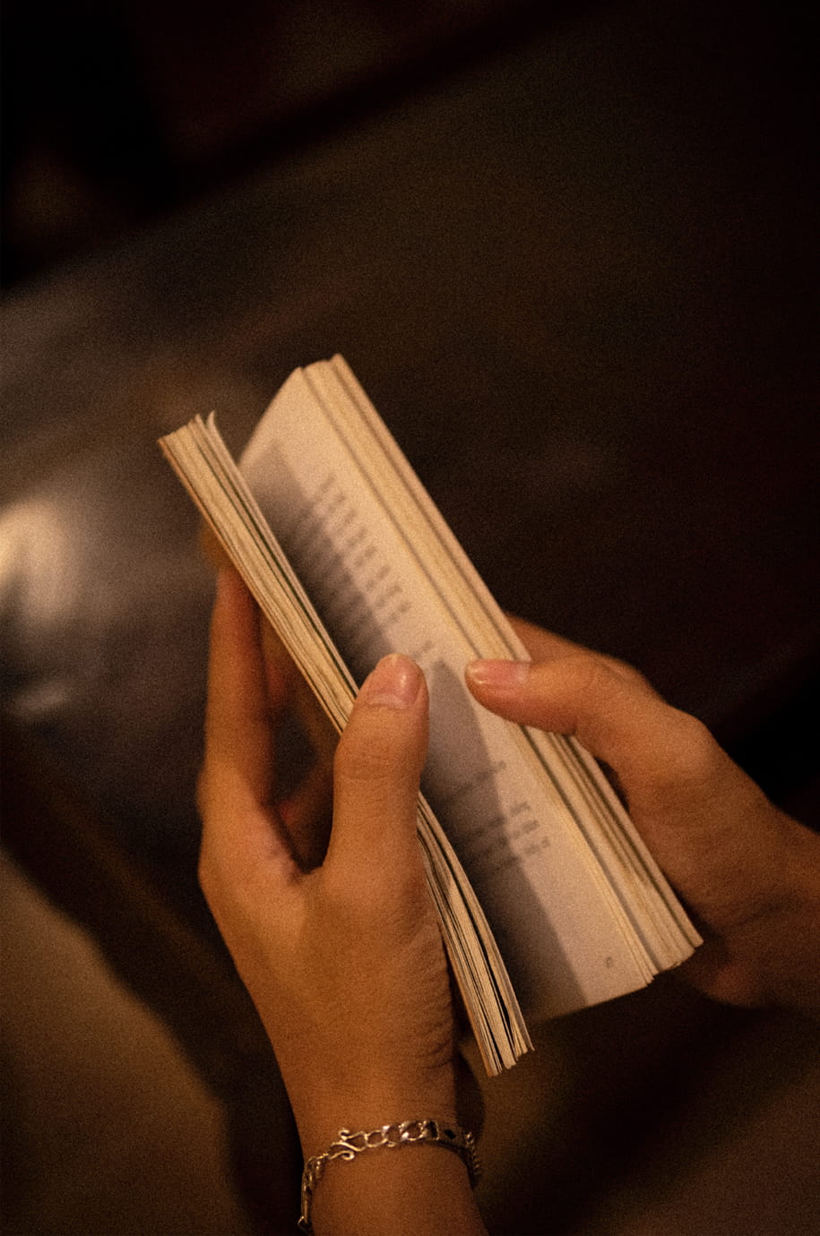 Antiquarisches Buch in Händen Hände halten ein aufgeschlagenes Buch als stimmungsvolles Motiv für das Antiquariat historicArt in Wiesbaden